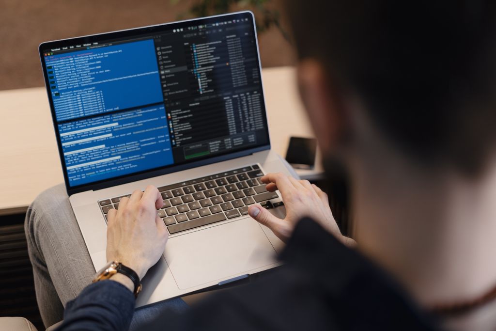 Close up man writing code on the laptop time to market, market entry, automatic assembly, electronics assembly, finished project, electronics programming
